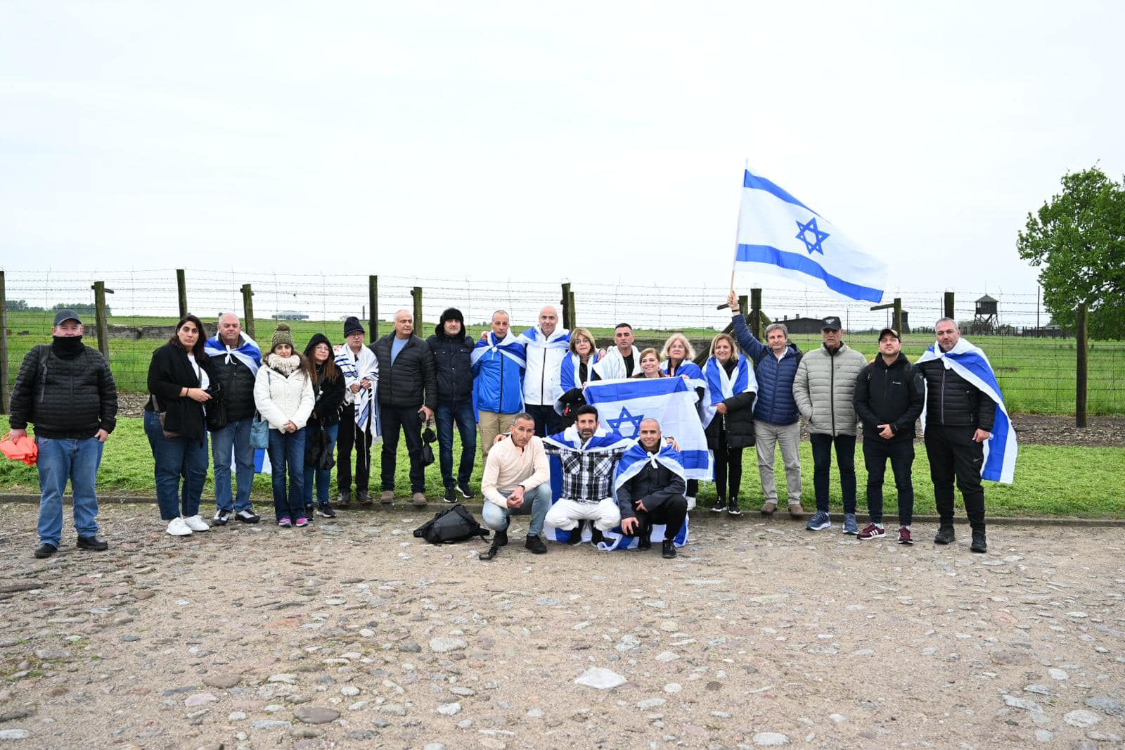 תצלום של כל משתתפי המסע אוחזים בדגל ישראל